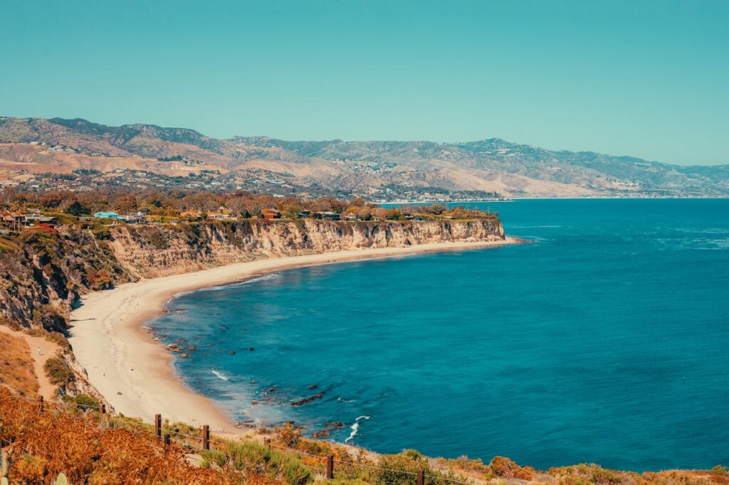 Explore the stunning cliffs and blue ocean waters of Malibu's coastline. Perfect for travel and nature enthusiasts.